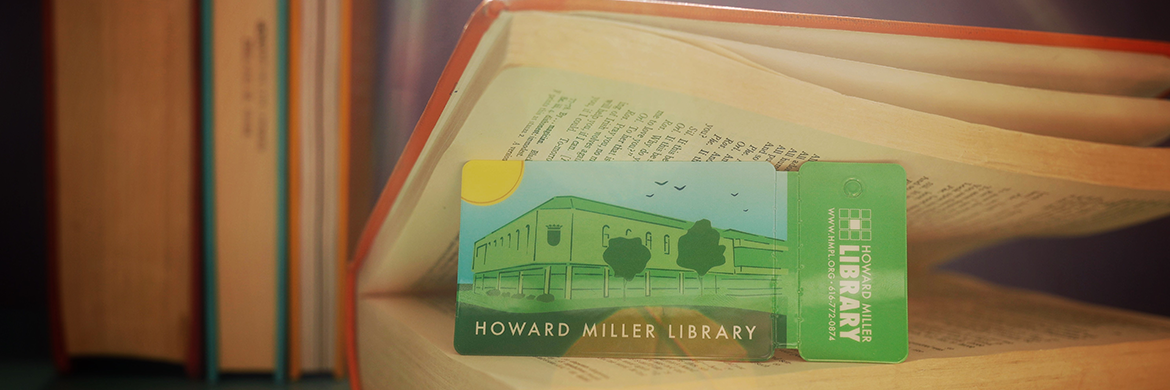 Howard Miller Public Library card sitting inside an open book