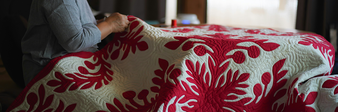 Woman working on a large quilt