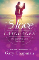 "The 5 Love Languages" book cover with a man and a woman embracing with a sunset and water in the background. 