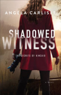 Image for "Shadowed Witness" with an image of a woman from behind.  She is in a red dress, holding a camera and looking over water