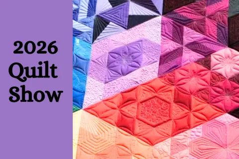Purple background on the left with "2026 Quilt Show" in black lettering.  To the right, colorful quilting patchwork in reds, blues and purples. 